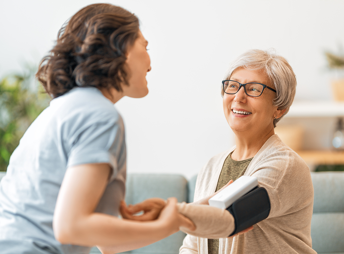 Nurse taking care of an oldwoman in her house