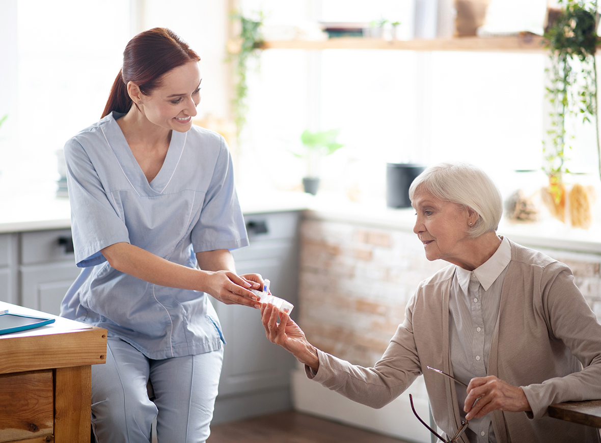 Nurse taking care of an oldwoman in her house
